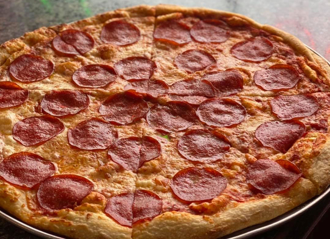 A pepperoni pizza on a metal pan, pictured on Venice Pizzeria’s official website.